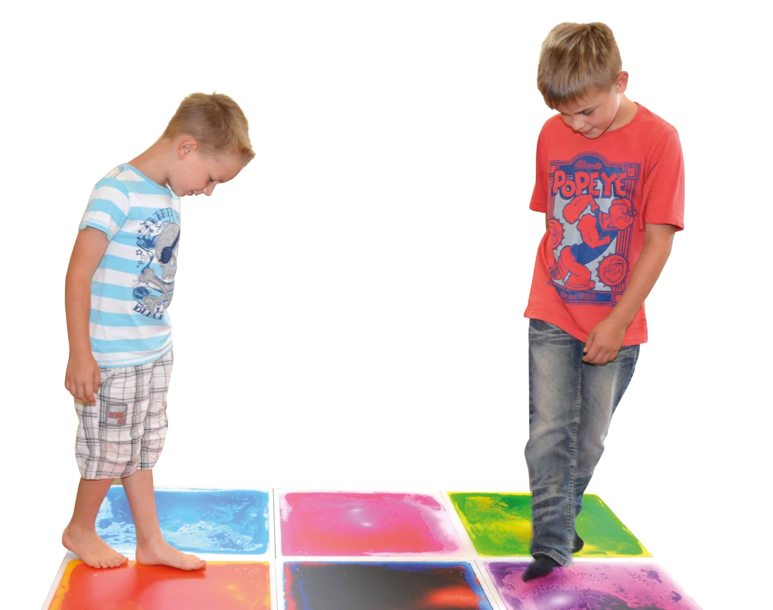 Kinderen stappen op kleurrijke Vloeistof Platen XL, die vloeistof in patronen laten bewegen voor motorische stimulatie.