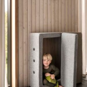 Multifunctioneel DK - PLAY Fold meubel met een kind erin, veilig en uitnodigend, perfect voor spelen en ontspannen.